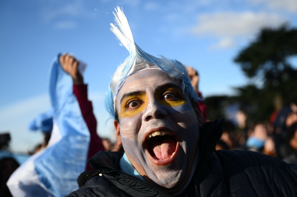An Argentina fan celebrates a goal scored by forward Lionel Messi while watching the FIFA World Cup 2026 Group J match between Argentina and Austria on a giant screen in Buenos Aires on June 22, 2026. — AFP pic