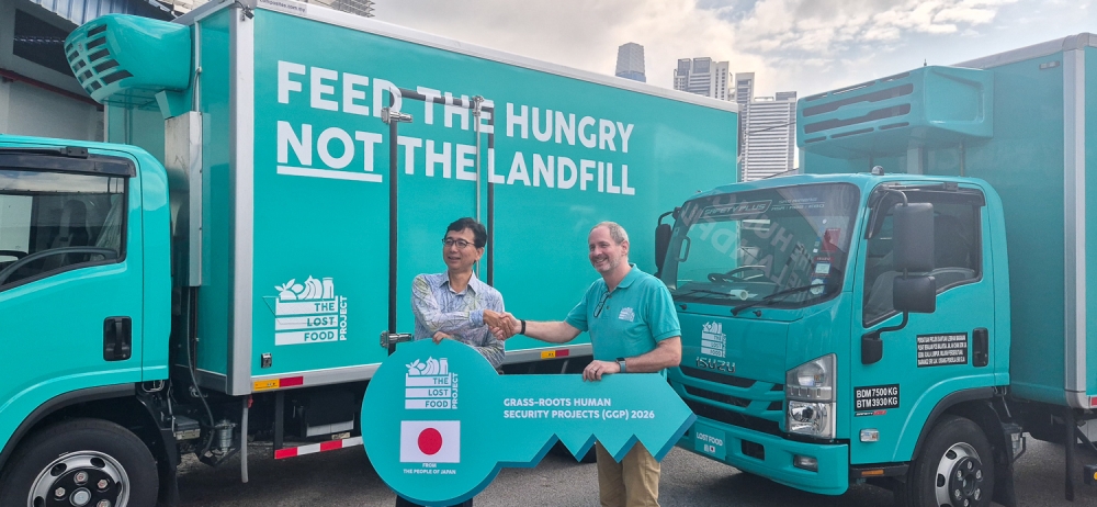 Japanese Ambassador to Malaysia, His Excellency Shikata Noriyuki (left), and The Lost Food Project President Geoff King hold a ceremonial key marking the handover of the newly donated refrigerated trucks at The Lost Food Project facility in Kuala Lumpur June 23, 2026. — Picture by Raymond Manuel