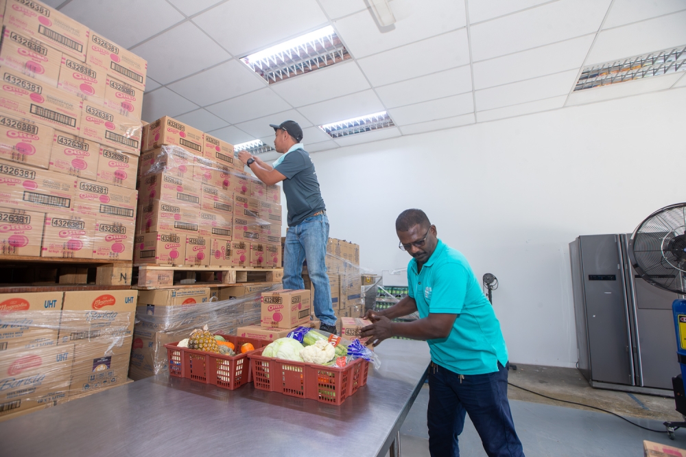 Volunteers organise boxes of food supplies and baskets of fresh produce inside a warehouse at The Lost Food Project facility in Kuala Lumpur June 23, 2026. — Picture by Raymond Manuel