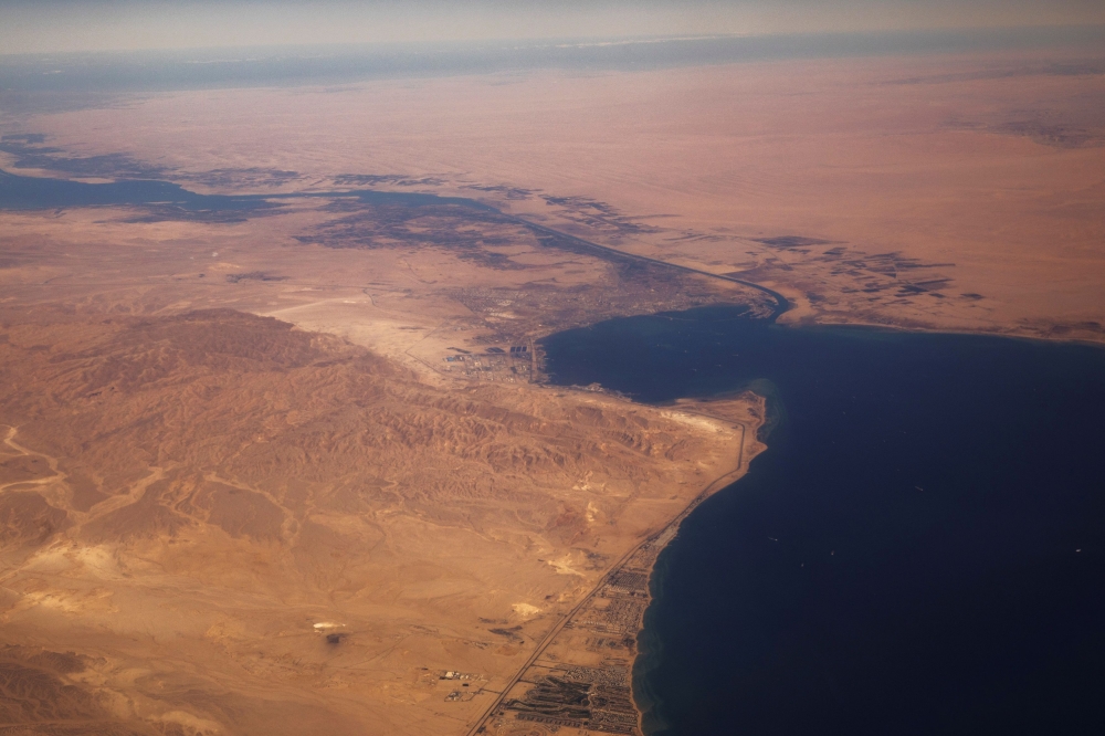 The Suez Canal connecting the Mediterranean Sea to the Red Sea is pictured from the window of a commercial plane flying over Egypt on December 18, 2019. — Reuters pic