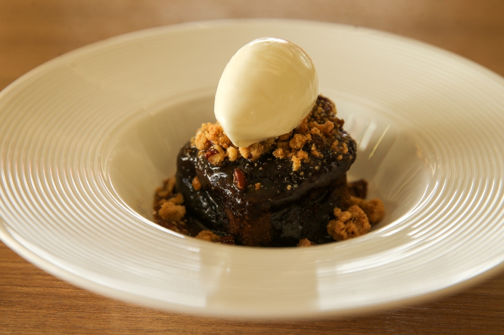 A heavenly bowl of syrupy comfort, the sticky date pudding is another popular dessert at Nude. — Picture by Choo Choy May