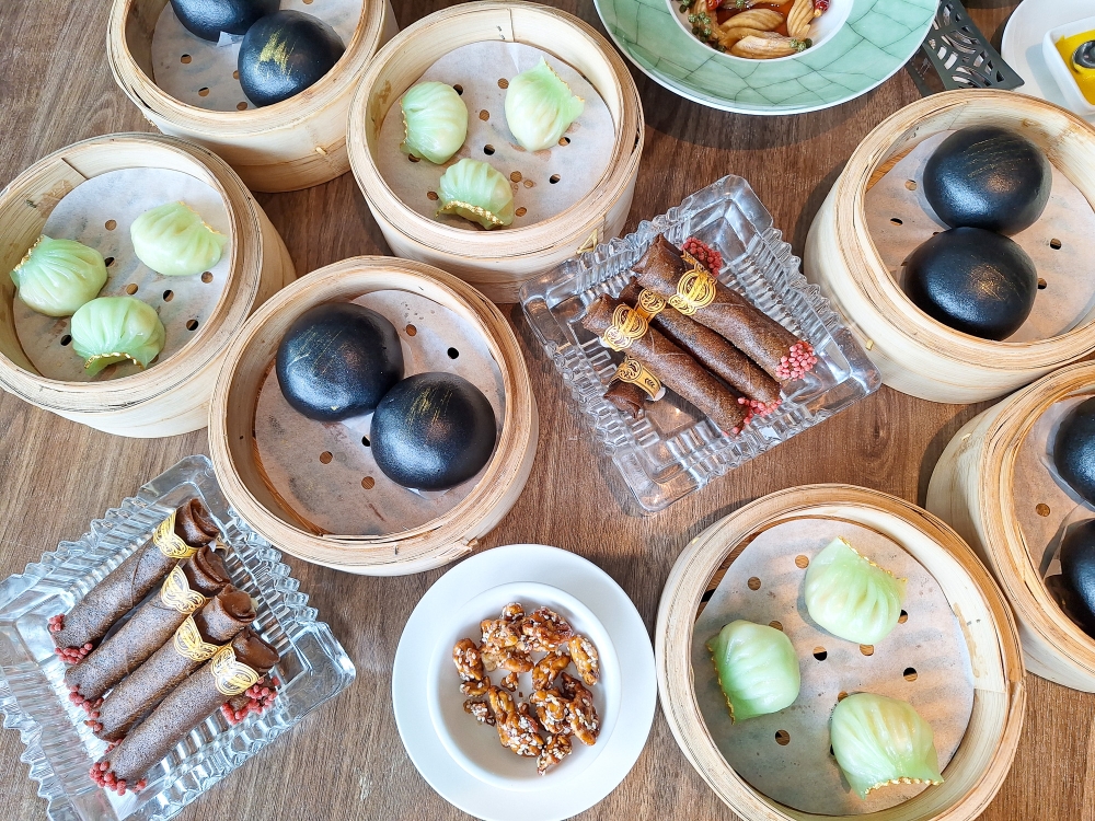 Cigar-shaped mini spring rolls, salted egg yolk custard buns, and a classic 'dim sum' dish 'har gow' (shrimp dumplings) at King Lung Heen, Hong Kong. — Picture by Ida Lim