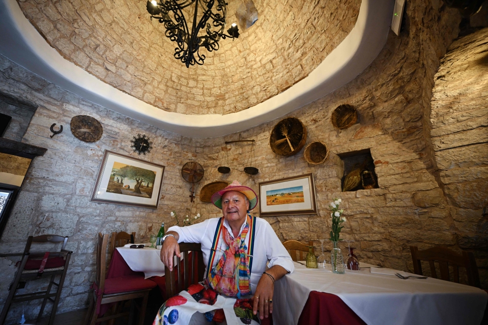 Domenico Laera, owner of a restaurant located in a dry-stone dwelling with conical roofs called ‘trullo’, poses in Alberobello, in the southern region of Puglia, on June 24, 2026. — AFP pic