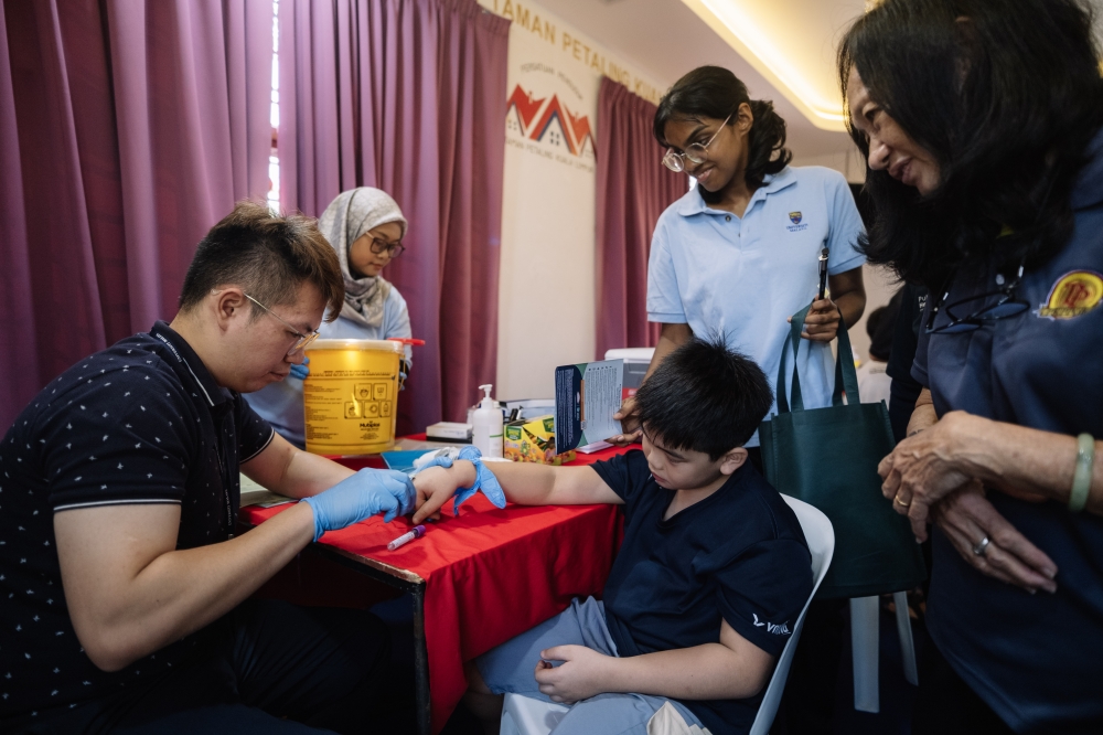 Blood taken for anaemia screening during Universiti Malaya’s community health drive in Kepong. — Bernama pic
