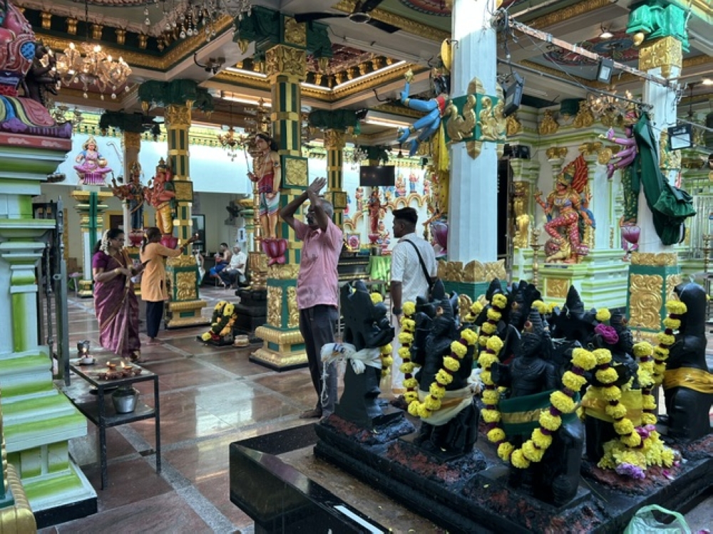 Devotees offering prayers in the temple. — Picture by Opalyn Mok