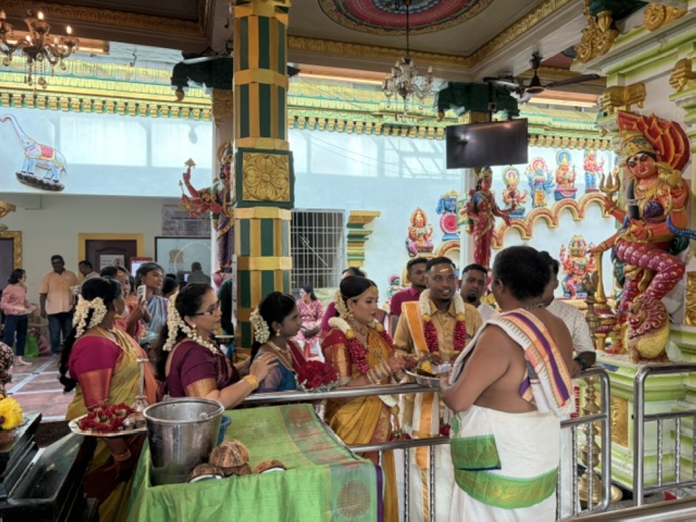 A priest conducting a traditional wedding ceremony in the temple.— Picture by Opalyn Mok