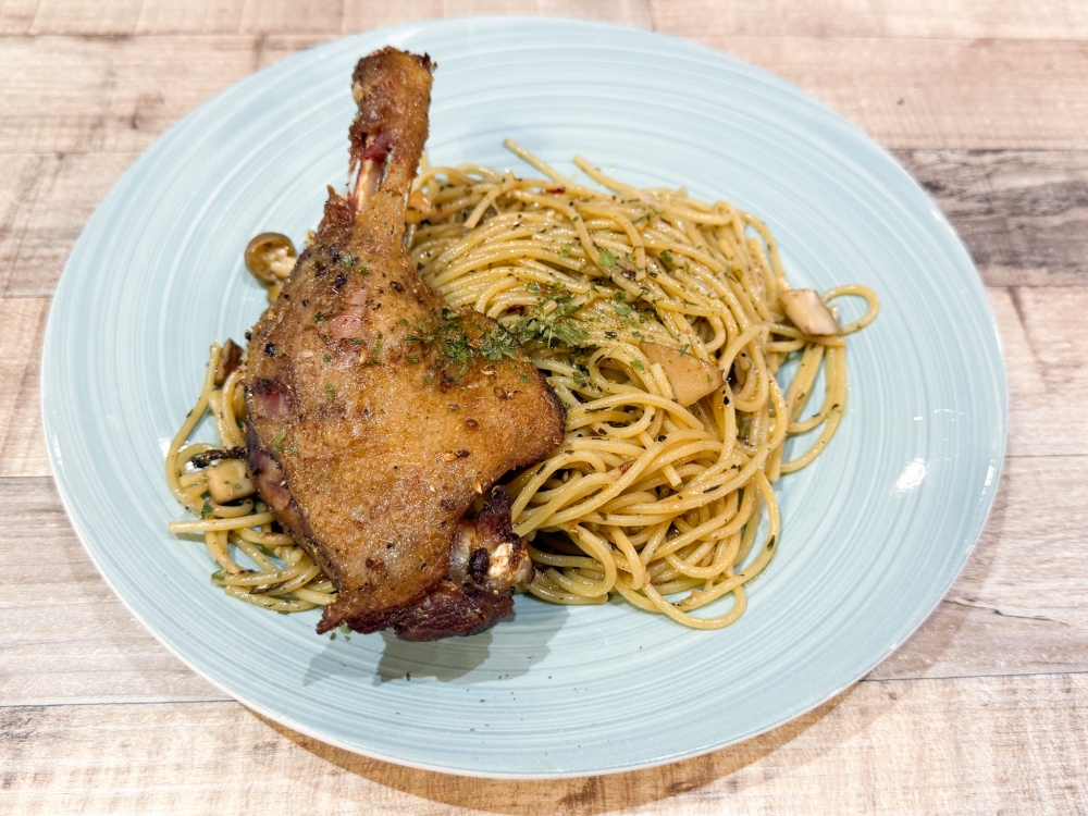 French Whole Duck Leg Confit with Spaghetti Aglio Olio isn’t your typical no-frills Western meal but the duck dish stems from the chef’s French cuisine experience — Picture by Lee Khang Yi