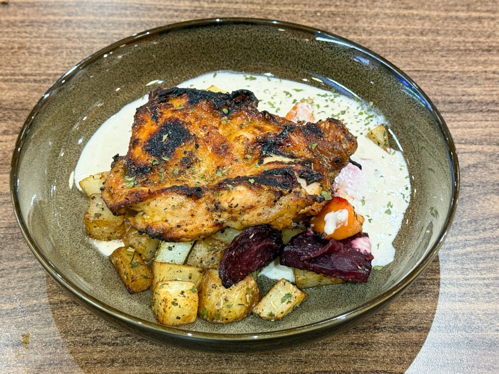 Set meals can be ordered, and they rotate like this: Grilled Chicken with smoky flavours and a well-caramelized exterior, paired with roasted roots, potato persillade and onion cream — Picture by Lee Khang Yi