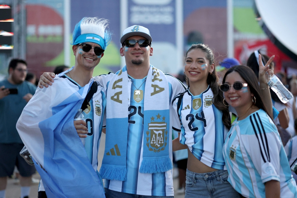 ARLINGTON, TEXAS - JUNE 27: Fans of Argentina pose for photographs before the FIFA World Cup 2026 Group J match between Jordan and Argentina at Dallas Stadium on June 27, 2026 in Arlington, Texas. — Getty Images via AFP