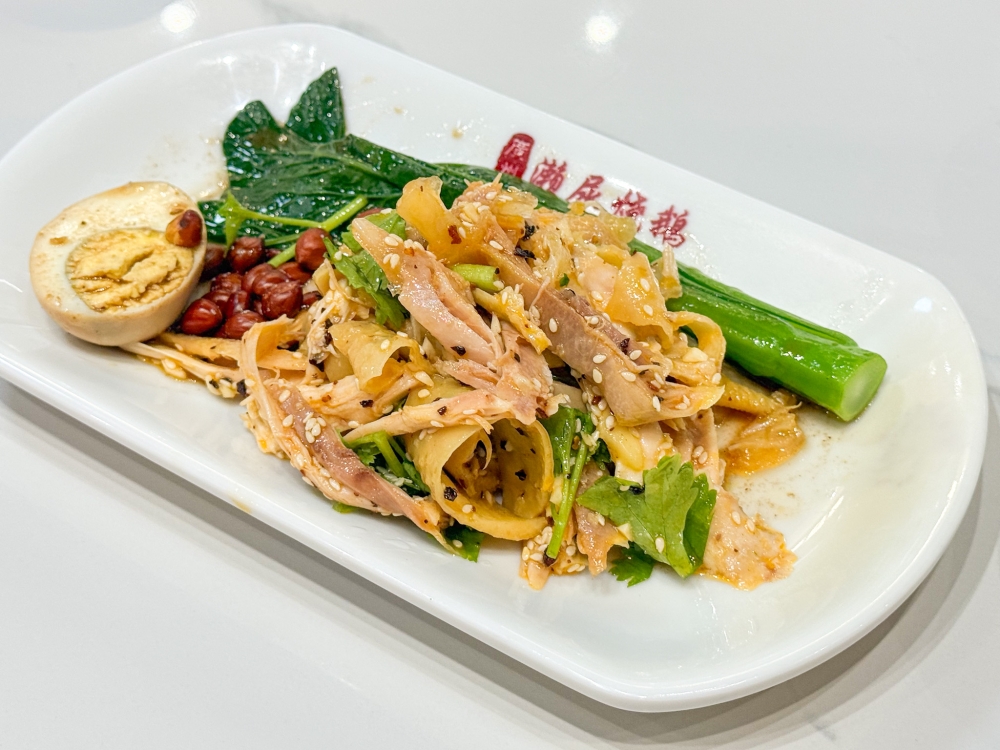 Hand-torn Chicken is a Foshan specialty where poached chicken with exceptionally crunchy skin is shredded and tossed with chopped garlic and sesame seeds. 