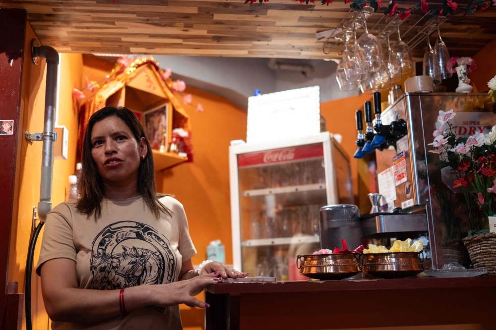 Budhathoki Samjhana, a restaurant owner and business manager visa holder at Chitwan Rhino Restaurant and Bar, looks on inside her bar in the Okubo亡hin area, one stop north of Shinjuku, in Tokyo on June 12, 2026. — AFP pic 