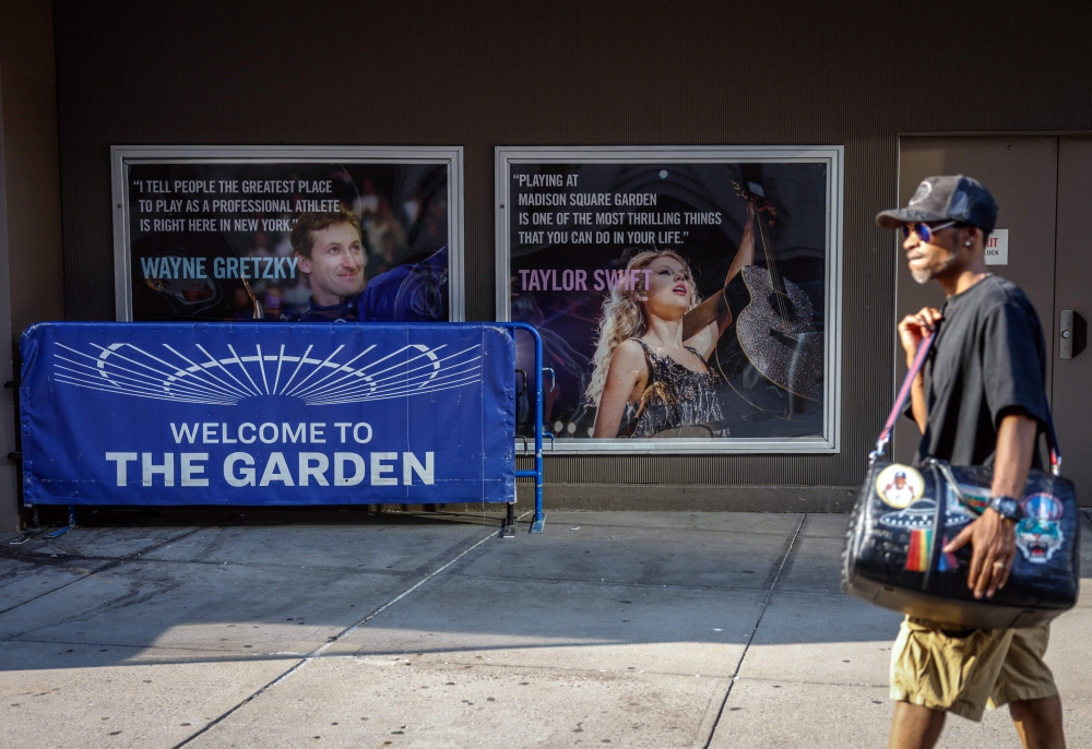 A person walks by a poster featuring an image and quote from US singer-songwriter Taylor Swift outside Madison Square Garden in New York on July 1, 2026. — AFP pic