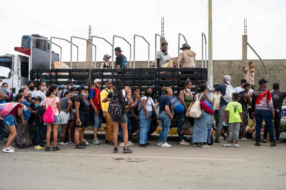 People queue to receive food and items from volunteers in Caraballeda, La Guaira state, Venezuela on June 30, 2026, following twin earthquakes on June 24. — AFP pic