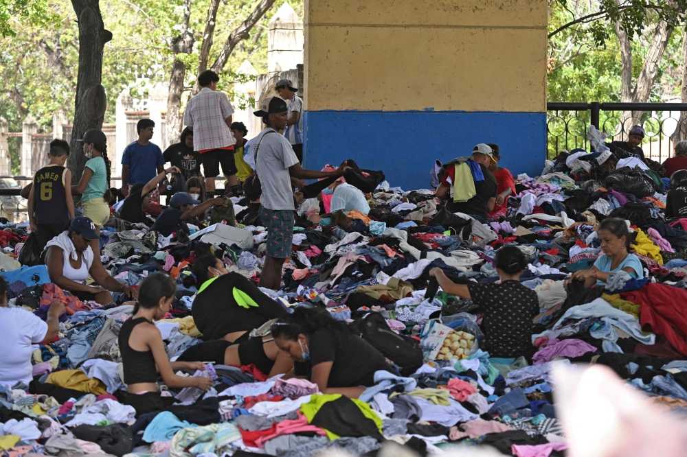Residents look for clothes at a collection center in Caraballeda, La Guaira state, Venezuela on July 1, 2026, following twin earthquakes on June 24. — AFP pic