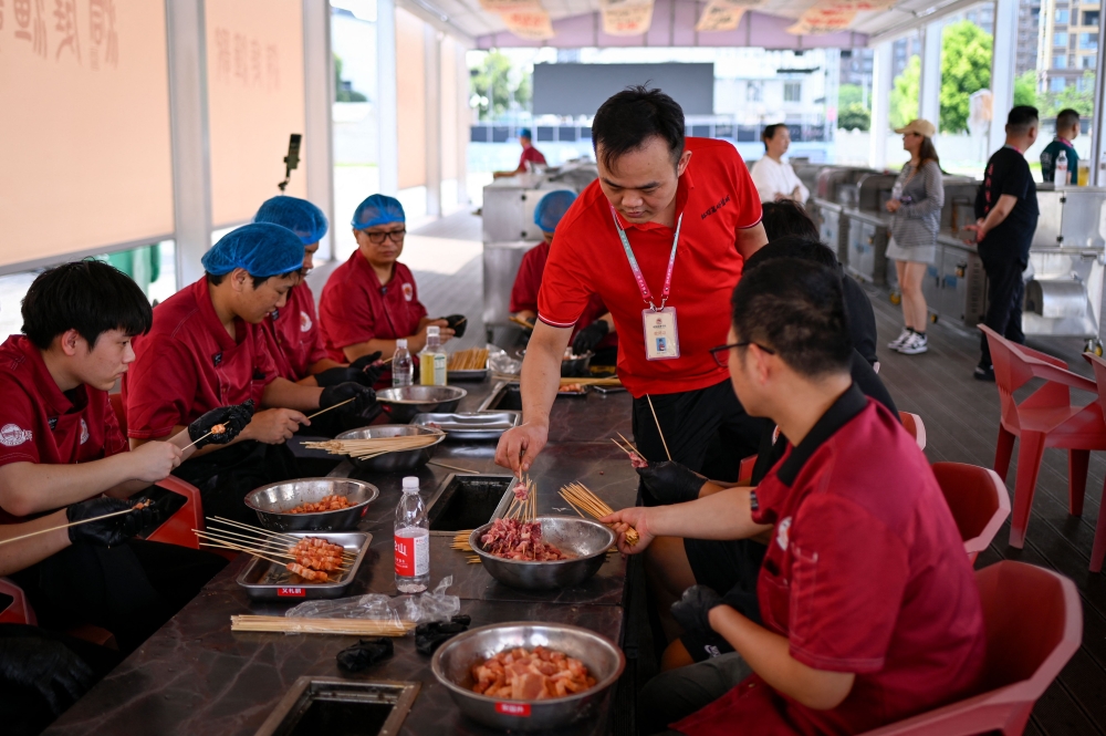 Though the academy only admitted its first batch of students in April, founder Jiang Zongfu aims to train 10,000 grill masters within five years. — AFP pic