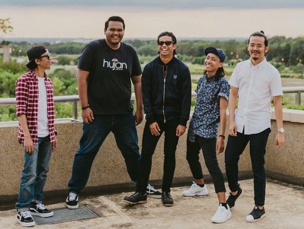 Poji (second from left) posing with Hujan members. — Picture courtesy of Fauzy Ramly