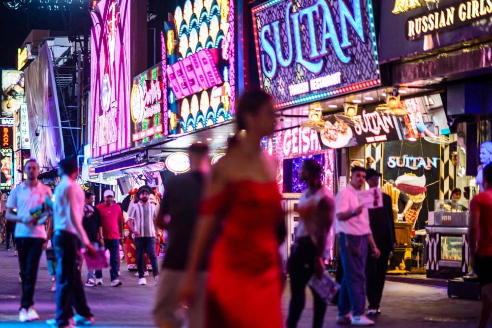 People walk past bars and clubs along Walking Street in Pattaya on July 3, 2026. — AFP pic
