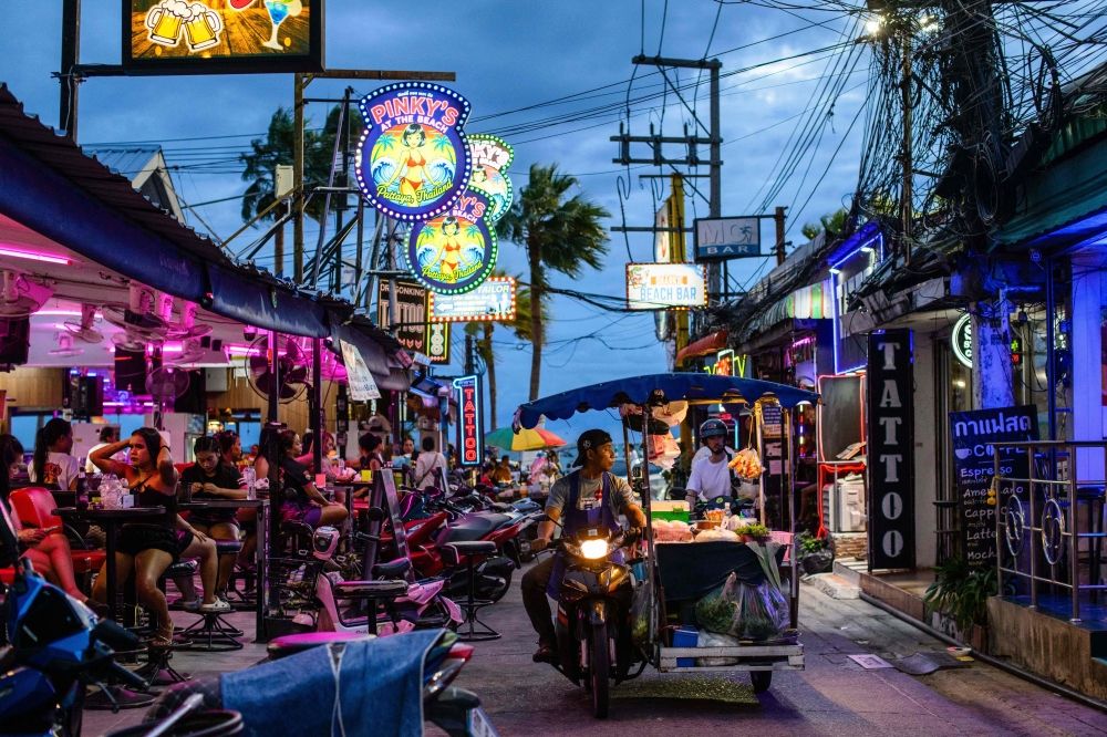 A food vendor drives past bars near Pattaya Beach, in Pattaya on June 29, 2026. — AFP pic
