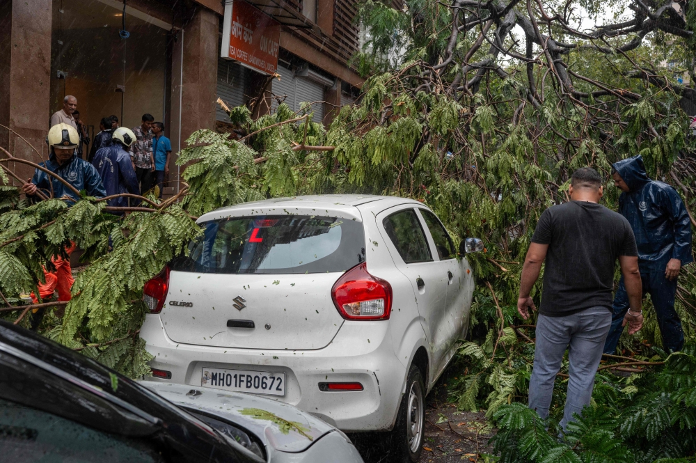 Building collapse kills six in Mumbai as torrential rain batters city
