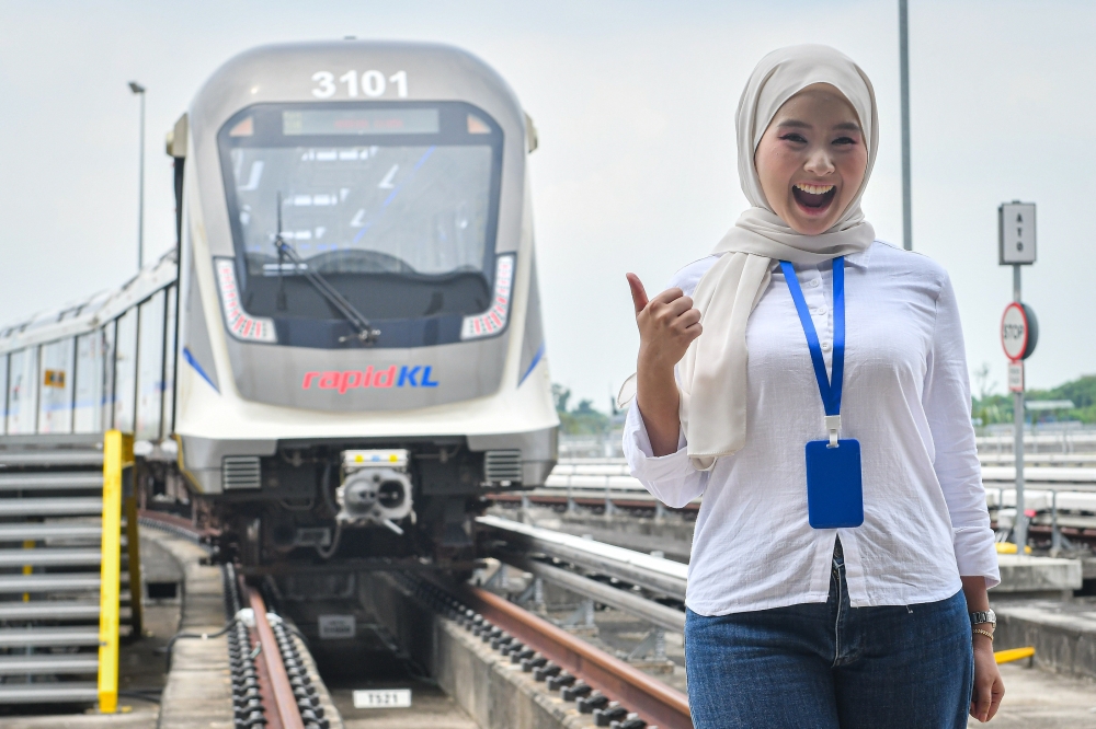 A commuter poses in front of a Shah Alam Light Rail Transit Line 3 (LRT3) train at the Johan Setia Station in Klang on June 28, 2026. — Bernama pic