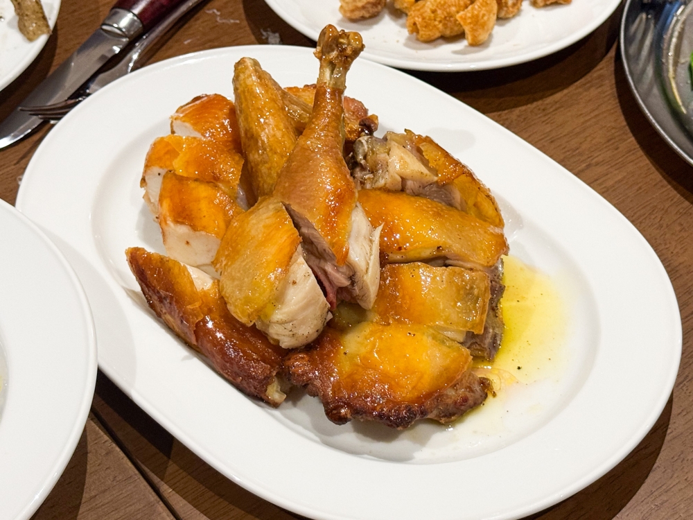 It's not all about pork in the menu as the Half Roasted Ma Cao Chicken offers lovely golden skin and succulent meat. — Picture by Lee Khang Yi