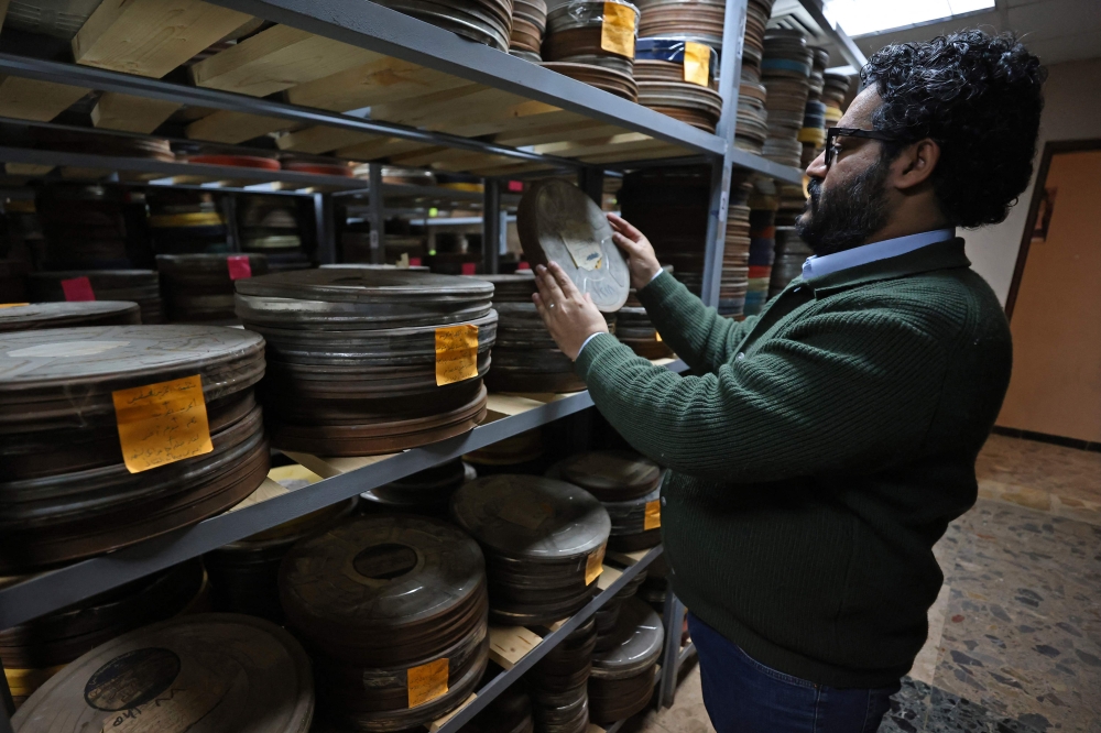 Filmmaker and cultural project manager Wareth Kwaish inspects a film reel at the National Centre for Archives and Iraqi Memory in Baghdad on February 5, 2026. — AFP pic