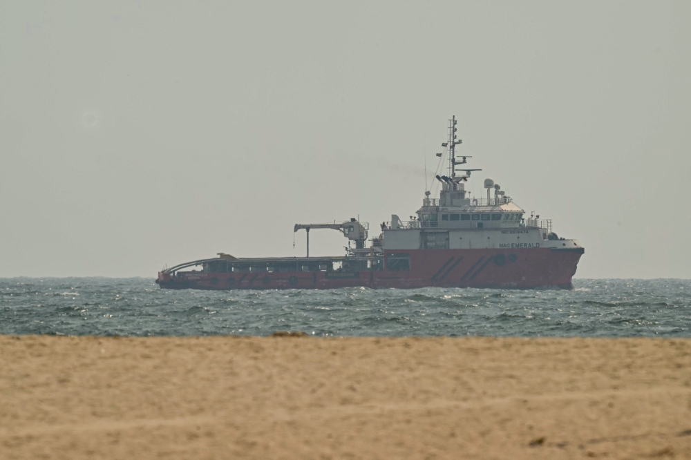A ship sails off the coast of Ajman on July 10, 2026. Traffic through the Strait of Hormuz has fallen sharply since July 8, especially through the UN-backed Omani route, analysts said, after vessels were attacked earlier this week and as the United States and Iran traded renewed strikes. — AFP