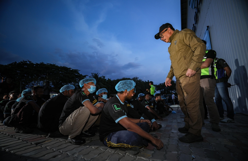 Perak Immigration Department director Datuk James Lee addresses foreign workers detained during a raid at a rubber glove factory in Chemor, Perak, April 8, 2026. The writer calls for a more balanced approach that combines enforcement with humane and practical policies. — Bernama pic