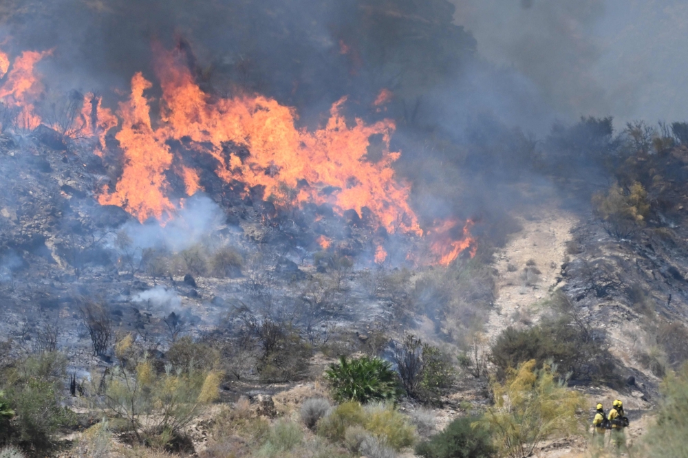 Firefighters of the Infoca (Andalusia Wildfire Service) work to extinguish fire in the area of a wildfire that killed 11 near Bedar, in Los Gallardos district, in Almeria Province, on July 10, 2026. Eleven people were killed and 19 are missing after a wildfire tore through a Spanish village, with four victims who may have been British who were burned in their car, authorities said. — AFP pic