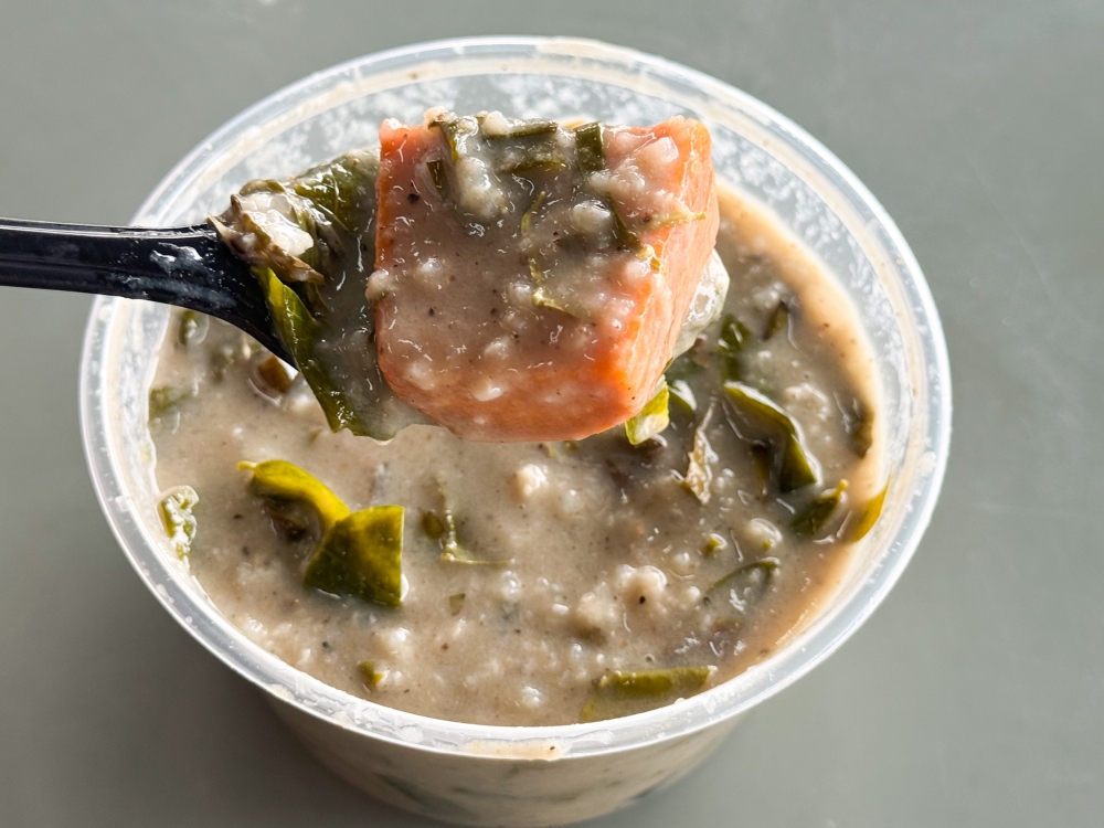 Weekend special is Bubur Lambuk Terengganu that differs from the usual porridge served as this version is full of foraged 'pucuk midin' and sweet potato. — Picture by Lee Khang Yi