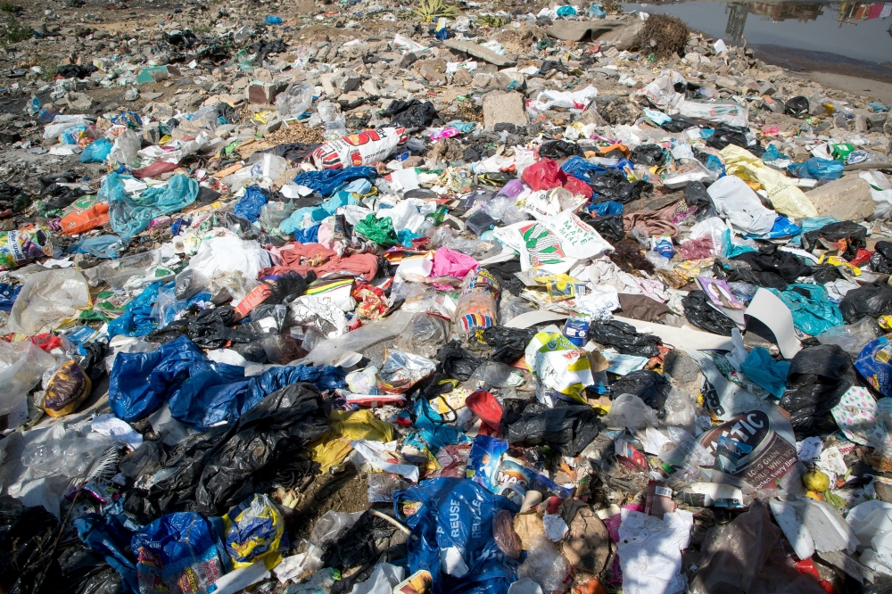 Nine die after rain-soaked garbage heap collapses at India waste plant