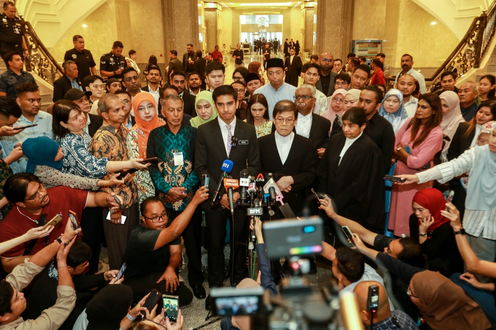 Muar MP Syed Saddiq Syed Abdul Rahman speaks to reporters outside court on July 13, 2026. His case involving charges under Section 403 of the Penal Code centred on allegations involving RM120,000 transferred from an Armada-linked account. — Picture by Sayuti Zainudin