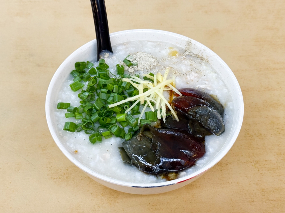 Porridge served at this stall has a creamy texture and fragrance from the use of jasmine rice, paired with a century egg with a soft centre. — Picture by Lee Khang Yi