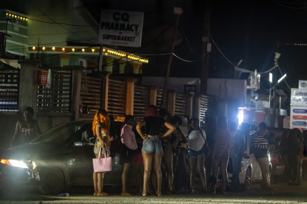 Sex workers are seen standing at night on the streets in Benin City on May 21, 2026. — AFP pic 
