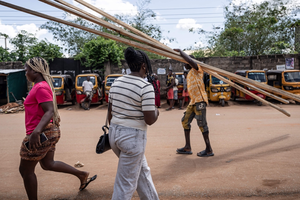 Promise, is seen crossing the road on her way to pick up her son from school in Benin City on May 20, 2026, where she lives after returning to Nigeria in 2025 following more than 10 years of trafficking overseas. — AFP pic 