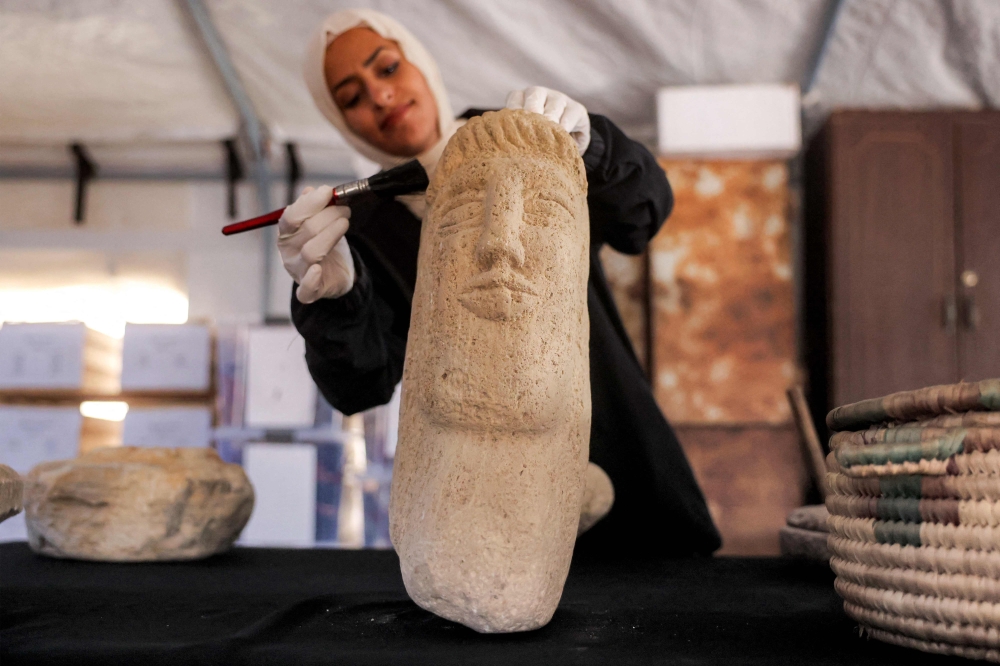 Paintbrushes and plastic boxes safeguard Gaza’s cultural treasures as bombs flatten landmarks