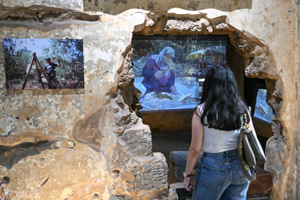 A visitor walks through the ‘Hkeeli ya Jnoub’ (‘Tell Me, O South’) exhibition in Beirut on July 17, 2026. The exhibition features ‘Keys Without Homes’ by artist Adeeb Farhat, preserving memories of homes destroyed in southern Lebanon. — AFP pic