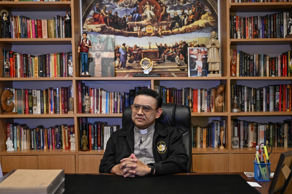 Catholic priest Father Jose Francisco Syquia sitting during an interview with AFP at the Saint Michael Center for Spiritual Liberation and Exorcism in Makati, Metro Manila, Asia's only dedicated exorcism centre. — AFP pic