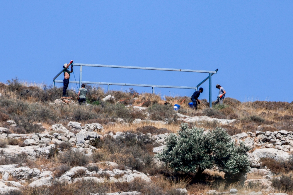 Israeli settlers build a new outpost at the Palestinian village of Azmut in the occupied West Bank on July 17, 2026. — AFP