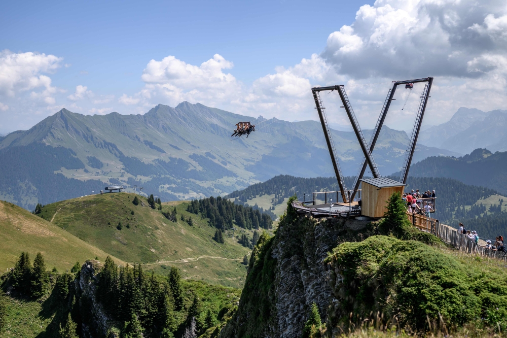 This photograph shows tourists enjoying the new BalancAIR, a giant swing at the top of the Grand Chamossaire peak, above Villars-sur-Ollon, Switzerland, on July 20, 2026. — AFP pic