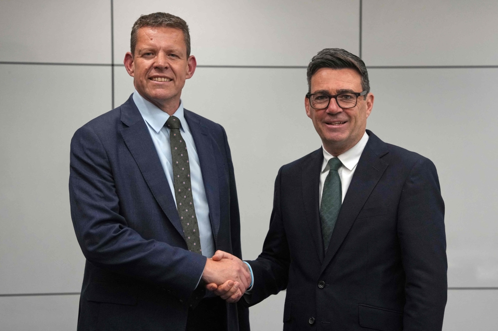 Britain’s Prime Minister Andy Burnham shakes hands with Plaid Cymru leader, Rhun ap Iorwerth in Glasgow, July 23, 2026. — Alastair Grant/Pool/AFP pic