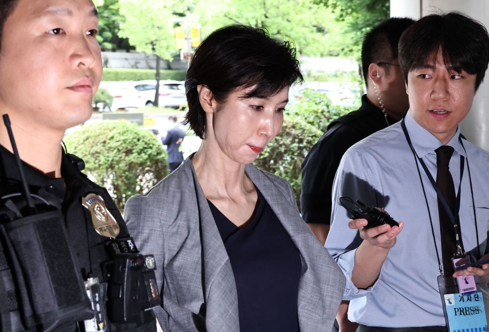 This picture taken on June 26, 2026 shows Roh Soh-yeong, director of Art Centre Nabi, arriving at a court to attend her retrial regarding the division of assets with her former husband SK Group Chairman Chey Tae-won at the Seoul High Court in Seoul. — Yonhap/AFP pic