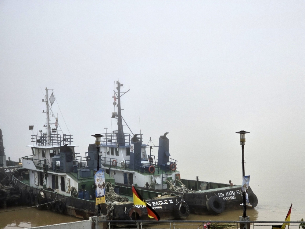 Dense fog shrouds the Rajang River in Sibu, leaving the waterway barely visible. — The Borneo Post pic