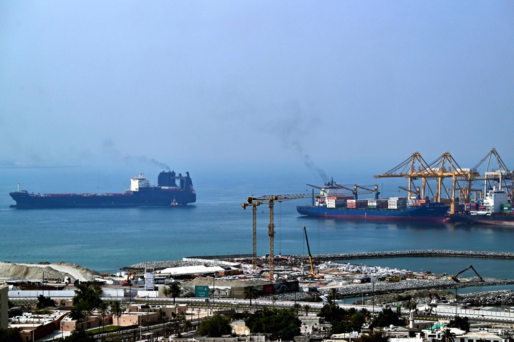 Ships are docked along a pier at the Khor Fakkan Container Terminal, the only natural deep-sea port in the region and one of the major container ports in Sharjah Emirate, along the Gulf of Oman on July 14, 2026. — AFP pic