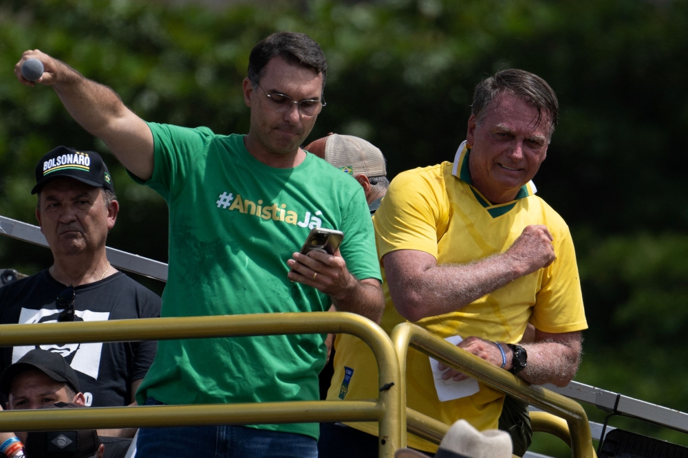 Brazil’s former president Jair Bolsonaro (right) and his son Senator Flavio Bolsonaro take part in a rally in Copacabana, Rio de Janeiro, Brazil, on March 16, 2025. — AFP pic