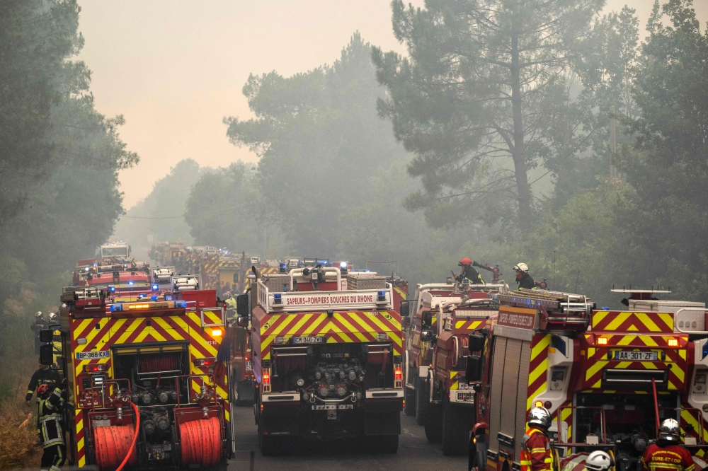 This photograph shows a column of firefighters vehicles near the town of Lacanau, in south-western France on July 25, 2026. — AFP pic