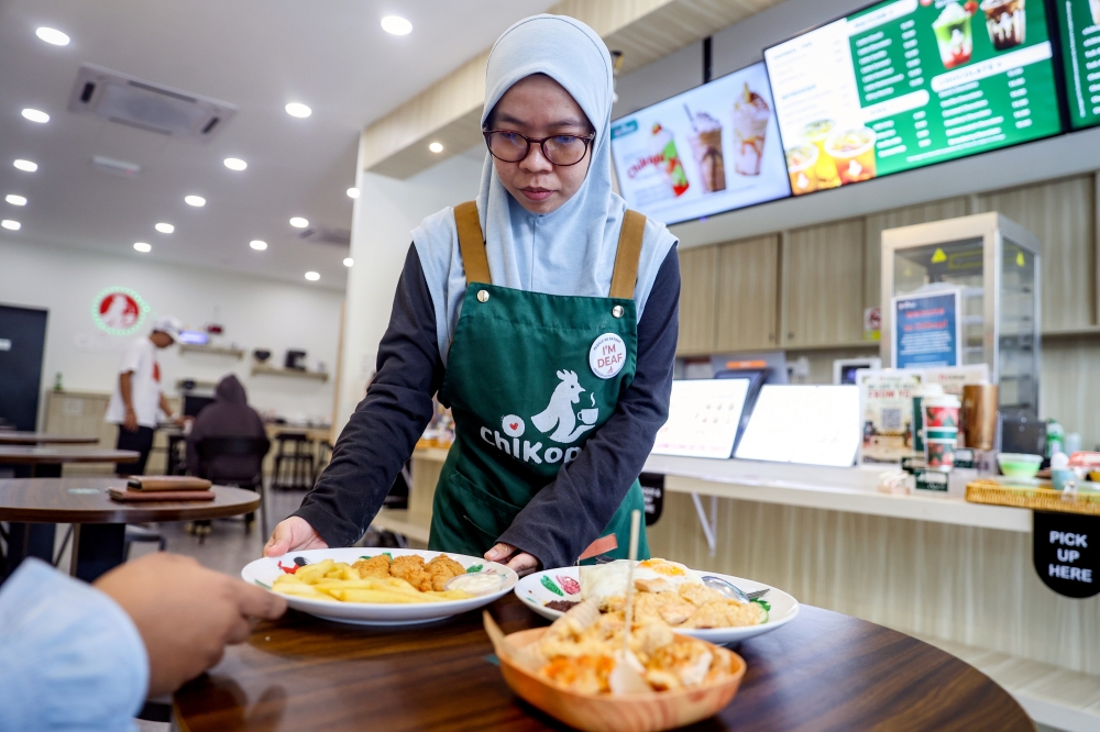 Nurul Amirah Azman, 29, who is hearing‑impaired, is one of Chikopi’s staff. — Bernama pic
