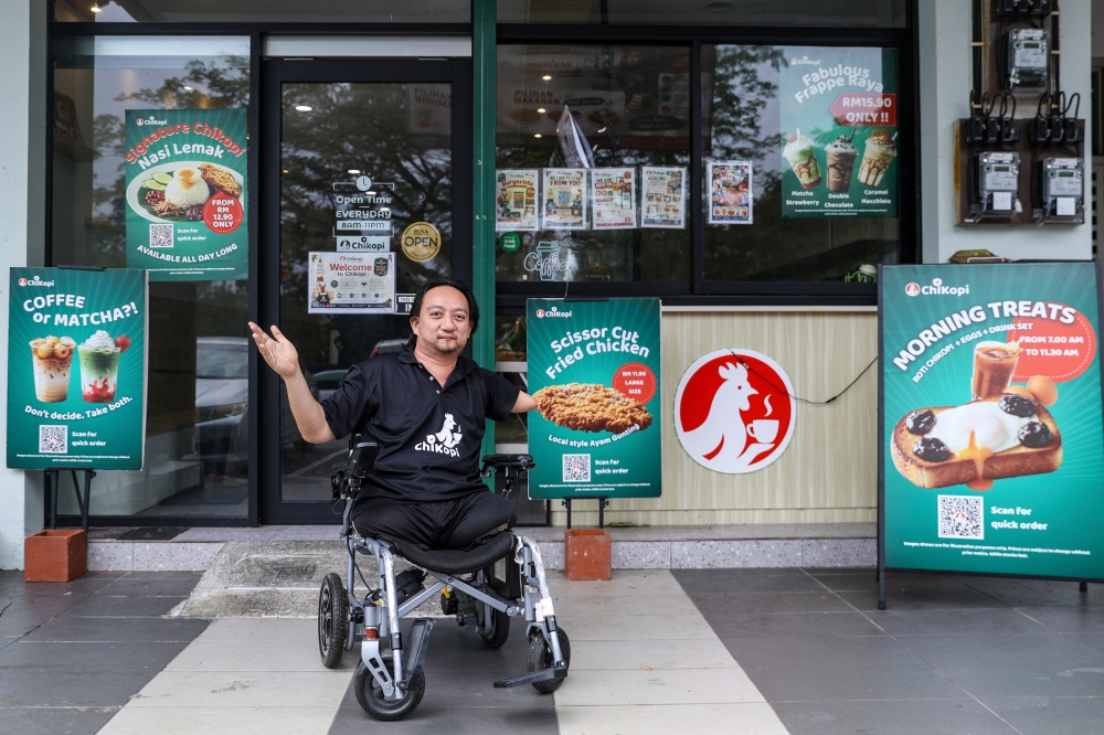 Chikopi founder Dr Ruzimi Mohamed, 42, poses outside his café in Johor Bahru recently. — Bernama pic