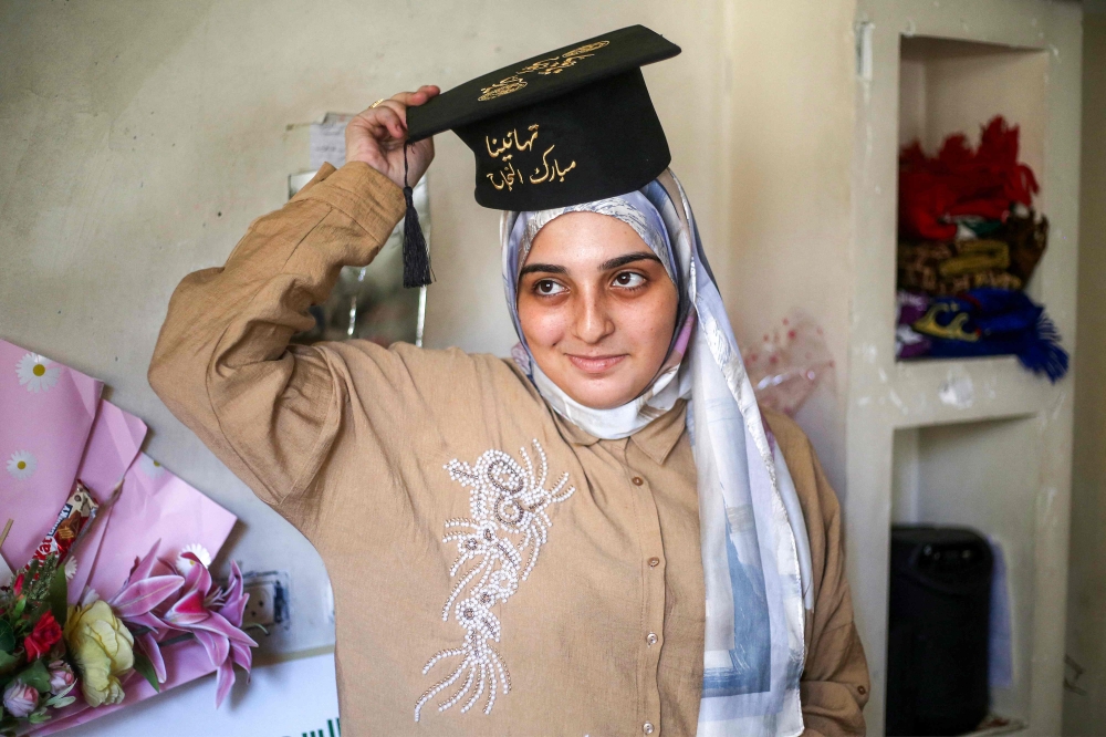 Palestinian highschool student Saba Rabah, the top-ranked student in the science stream of the Palestinian national high school exams, celebrates with family at the Maghazi camp for Palestinian refugees in the central Gaza Strip on July 26, 2026. Just days before her final secondary school examinations, the house opposite Rabah's temporary home was bombed, prompting her and her family to flee leaving behind everything they had. It was only the latest ordeal in a war that had already claimed her father, destroyed their family's home and forced them into repeated displacement. — AFP pic