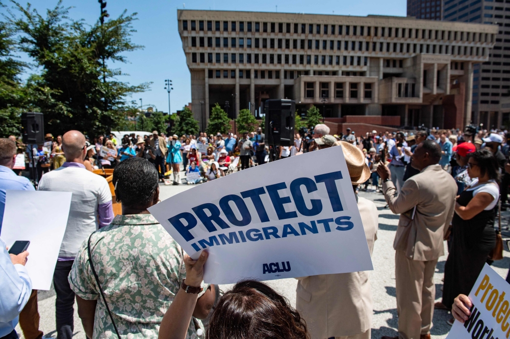 People hold signs at a rally calling on Congress to restore Temporary Protected Status (TPS) for Haitians, in Boston, Massachusetts July 23, 2026. — AFP pic